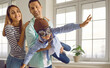 © Studio Romantic - Happy family with child playing and having fun at home. Father holding little son who is pretending to fly like an airplane. Happy little boy in pilot hat and goggles playing with his parents at home