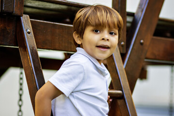 child, boy, 5 years old, cheerful, happy, smile, smiling, playing, fooling around, outdoors, park, fun, running, slide, swing, swing, blond, light hair, white, cute 