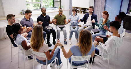 Group Of People Sitting Together Praying