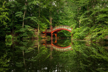 Ornate Wooden Bridge Over Very Calm Crim Dell Pond On Campus Of William And Mary College In Williamsburg Virginia