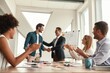 © Friends Stock - Welcome to our team Two cheerful colleagues shaking hands and smiling while having a meeting in the modern office