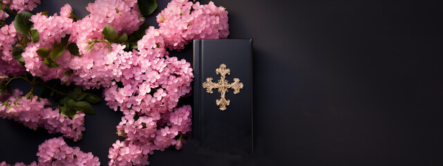Wall Mural - A Bible in a black leather cover with a gold cross on a wooden table with flowers. Christian religious background, banner.