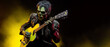 © Olena - Zombie musician playing guitar. Zombie man holds an electric guitar. Rock Musician. Hard rock party. Halloween party. Generative AI