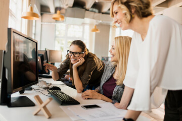 young women working on a project together in a startup company office