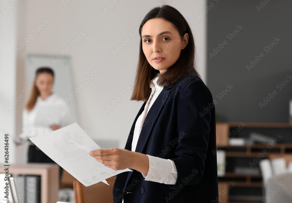 Female accountant with documents in office