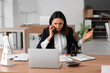 © Pixel-Shot - Stressed female accountant working at table in office