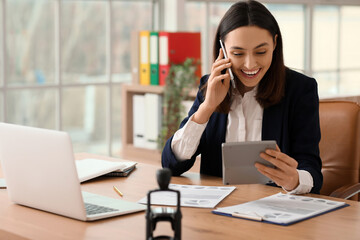 Sticker - Female accountant working with calculator at table in office