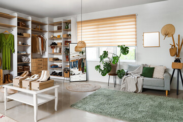 Wall Mural - Stylish clothes with shoes and accessories in light boutique