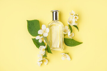 Wall Mural - Composition with bottle of perfume and beautiful jasmine flowers on yellow background