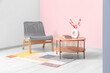 © Pixel-Shot - Grey armchair, coffee table and stylish rug near pink wall