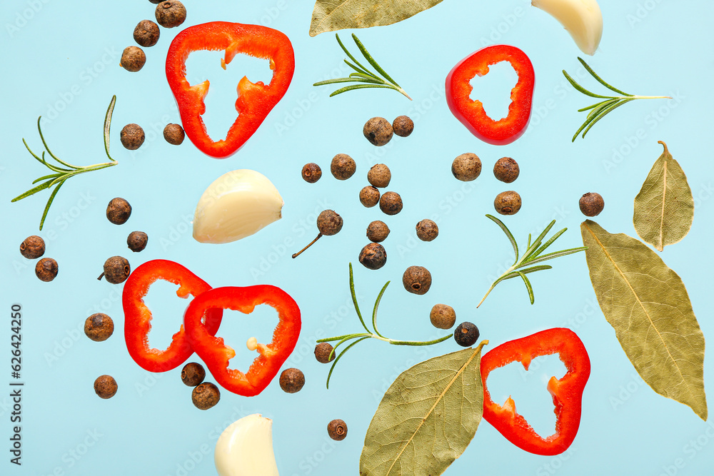 Flying spices on blue background, closeup