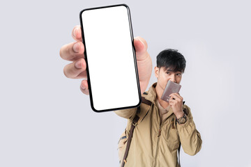 Asian man traveller showing cellphone blank screen with hand pointing to empty space for mobile app on screen. Isolated in studio white background. Creative collage.
