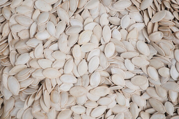 Sticker - White raw pumpkin seeds as background