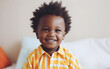 © Malchevska Studio - Black dark-skinned african american cute happy smiling boy portrait at home. Generative AI