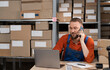 © Andrii Lysenko - Businessman calling on phone while working in a warehouse. Online store owner making controls product shipping. Entrepreneur man running an e-commerce small business.