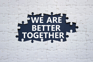 We are better together symbol. White puzzle with words We are better together. Beautiful black background. We are better together concept. Copy space.