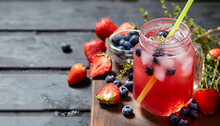 Berry Drink With Crushed Ice And Thyme. Strawberry And Blueberry Lemonade. Summer Refreshing Drink