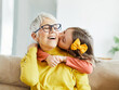 © Lumos sp - grandchild family child grandparent grandmother book reading elderly granddaughter girl happy together read learning education story fun leisure teaching storytelling senior smiling kiss hug
