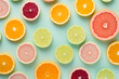 Mix of different citrus fruit slices like lemons and grapefruits on mint green background