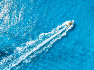 Wall Mural - vacation and leisure. aerial view on fast boat on blue mediterranean sea at sunny day. fast ship on 