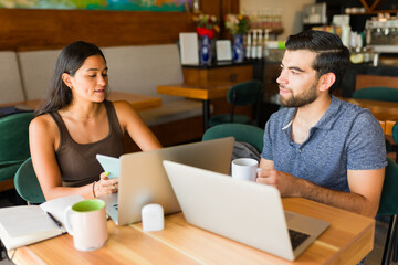 Wall Mural - Beautiful couple at the coffee shop doing remote work