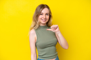 Wall Mural - Blonde English young girl isolated on yellow background proud and self-satisfied