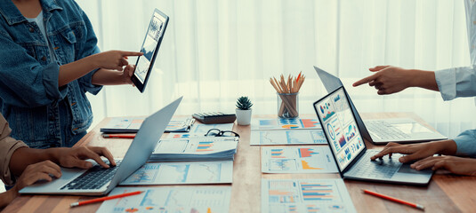 Fototapete - Panorama shot analyst team utilizing BI Fintech to analyze financial report with laptop. Businesspeople analyzing BI power dashboard displayed on laptop screen for business insight. Scrutinize