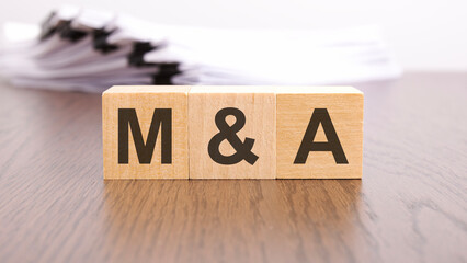 Sticker - m and a letters on wood block cubes on wooden table, marketing concept