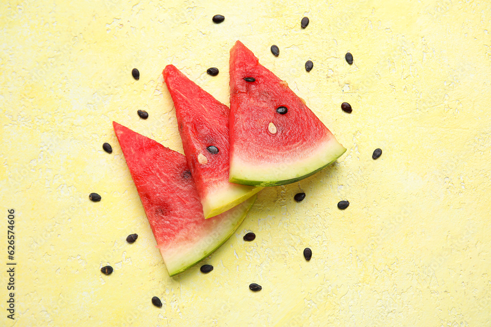 Composition with pieces of ripe fresh watermelon on yellow background
