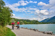 © Uwe - two senior girl friends having fun during a cycling tour at Lake Alpsee in the Allgau Alps near Immenstadt, Germany