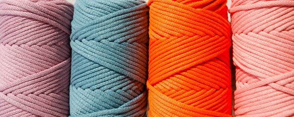 Colored skeins of thread for weaving macrame close-up.