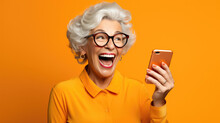 An Elderly Woman Exited And Shocked As She Saw Something On Her Phone Against An Orange Background.