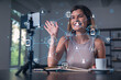 © VideoFlow - Happy woman is making video blog using smartphone on a tripod explaining with hands at office workplace. Concept of online stream, business education, conference call. Social network hologram