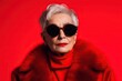 © iridescentstreet - Fashion portrait of stylish senior woman wearing deep red outfit and sunglasses