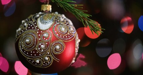 Aufkleber - Christmas tree decorated red ball toy, Fir branch with balls and festive lights on the Christmas background with sparkles and bokeh
