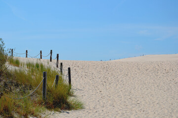 Wall Mural - Moving dunes in the Slovincian National Park also known as Slowinski National Park. Landscape with beautiful sand dunes touristic trail and the Baltic Sea, Leba. Poland