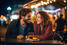 Joyful Caucasian Couple On A Date, Laughing And Enjoying Street Food In The City Nightlife