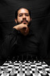 © Narayan - latin man with beard challenging in chess game, chess concept