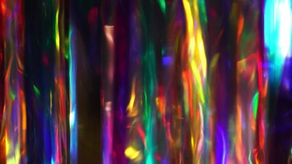 A diamond sparkling with different rainbow neon colors on a dark background. Prism Light Flares Overlay on Black Background