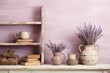 Provence-inspired home decoration with a shabby chic farmhouse interior. A vintage shelf adorned with a pitcher filled with lavender, an assortment of books, and wooden letters complements the pastel