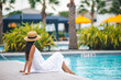 © travnikovstudio - Young beautiful woman enjoying summer vacation in infinity luxury swimming pool