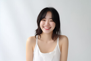 Wall Mural - An adorable Asian girl, donning a bright smile, is elegantly photographed in her underwear against a pristine white backdrop. generative AI.