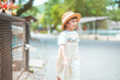 cute baby girl in dress and hat with activity sunny time