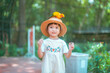 cute baby girl in dress and hat with activity feed food bird happy time