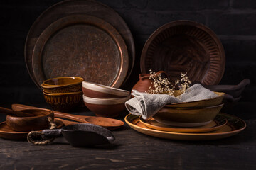 Sticker - Set of kitchen ceramic and wooden tableware a table.