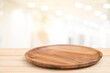 Empty wooden tray on perspective wooden table on top over blur background. Can be used mock up for montage products display or design layout.