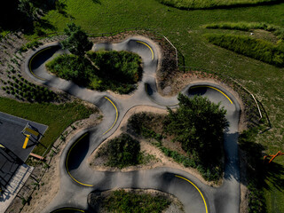 Sticker - bike path in the car park Pumping moving up and down is used instead of pedaling and bouncing to move bicycles, scooters, skateboards and inline skates along large pumptrack track