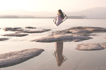 surreal image of a woman returning to the real world through a frame, abstract concept