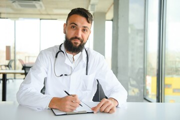 Handsome hispanic doctor man wearing stethoscope at the clinic with a happy and cool smile on face. Lucky person.