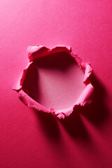 Wall Mural - Pink ripped paper background with hole in the center